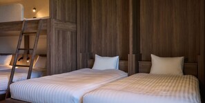 A bedroom with two beds, a wooden wardrobe, and a ladder. - Rakuten STAY Niseko (Niseko)