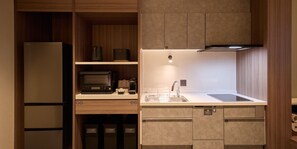 A compact kitchen with a refrigerator, microwave, and a sink. - Rakuten STAY Niseko (Niseko)