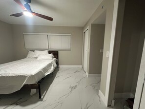 A bedroom with a bed, a ceiling fan, and a window with blinds. - Waterfront getaway, relaxation done right here (Fort Myers)