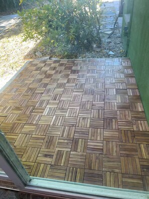 A wooden herringbone-patterned floor with a green wall and a window frame. - Waterfront getaway, relaxation done right here (Fort Myers)