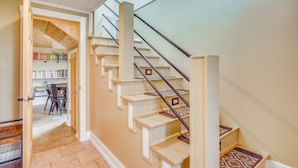 A staircase with a handrail, wooden steps, and a carpeted landing. - Bayfront Home! Dock, Deck, Hot Tub, & Fire Pit (Oconto)