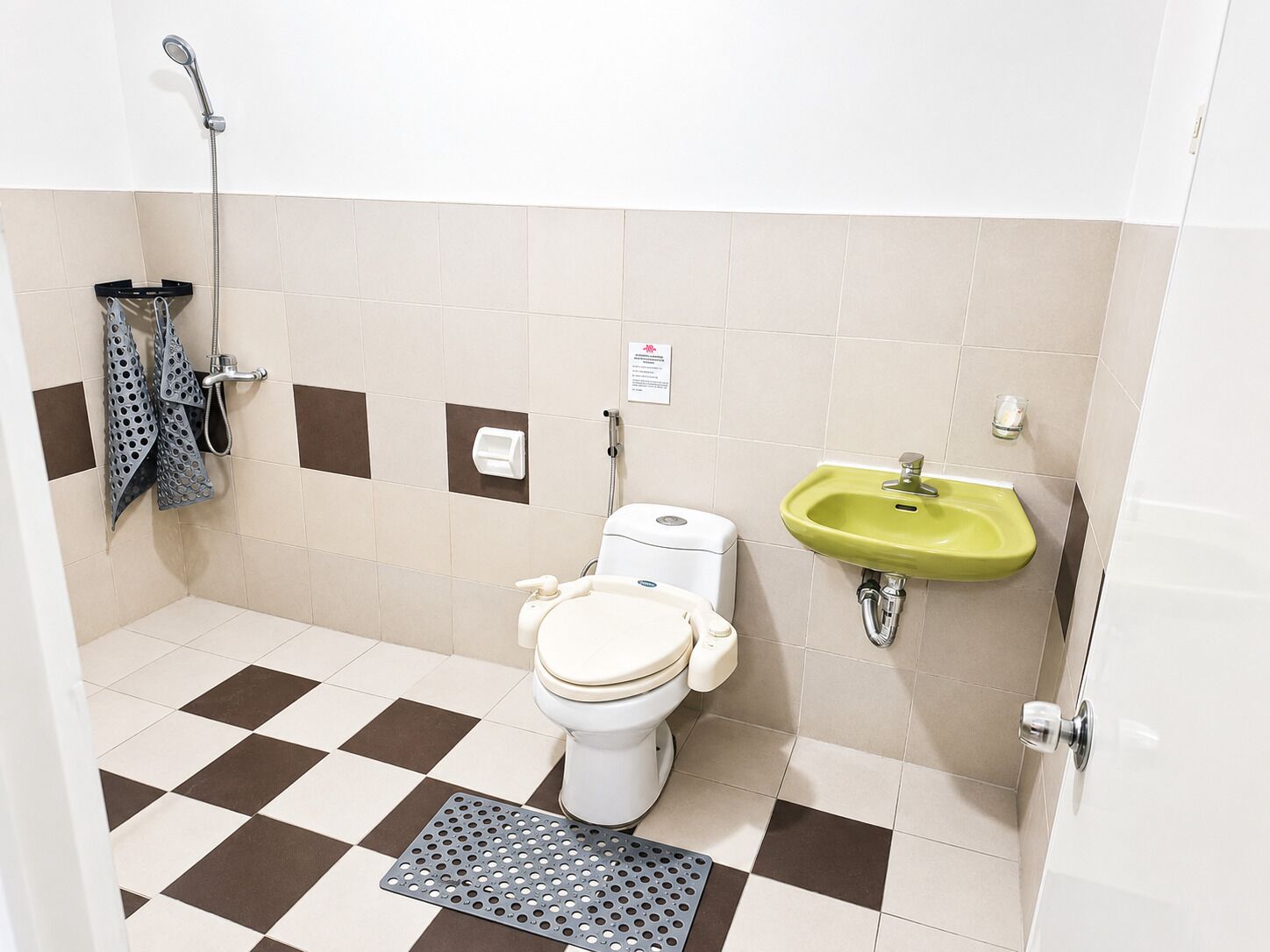A bathroom with a toilet, a sink, and a shower.