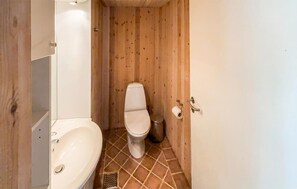 A compact bathroom with a white sink, toilet, and shower area. - 3 bedroom nice home in Skjern (Skjern)