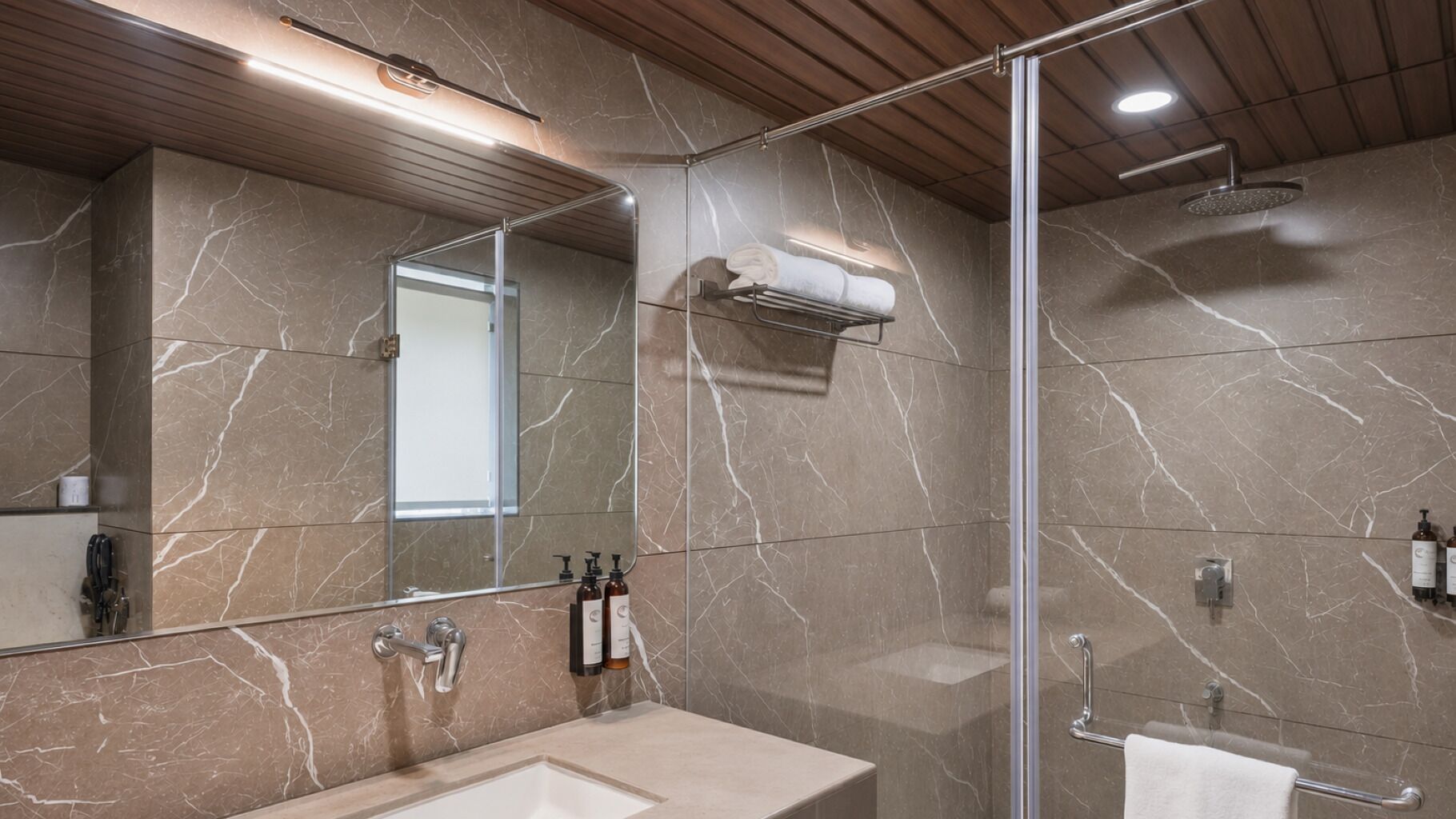 A modern bathroom with a marble floor, a large mirror, a glass shower enclosure, and a sink with a towel rack.