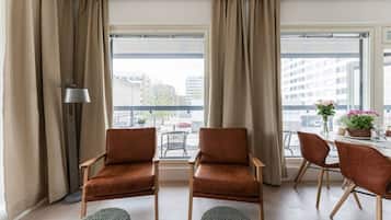 Deluxe Apartment, Balcony, City View, No Pets Allowed | Living area | 55-inch Smart TV with cable channels
