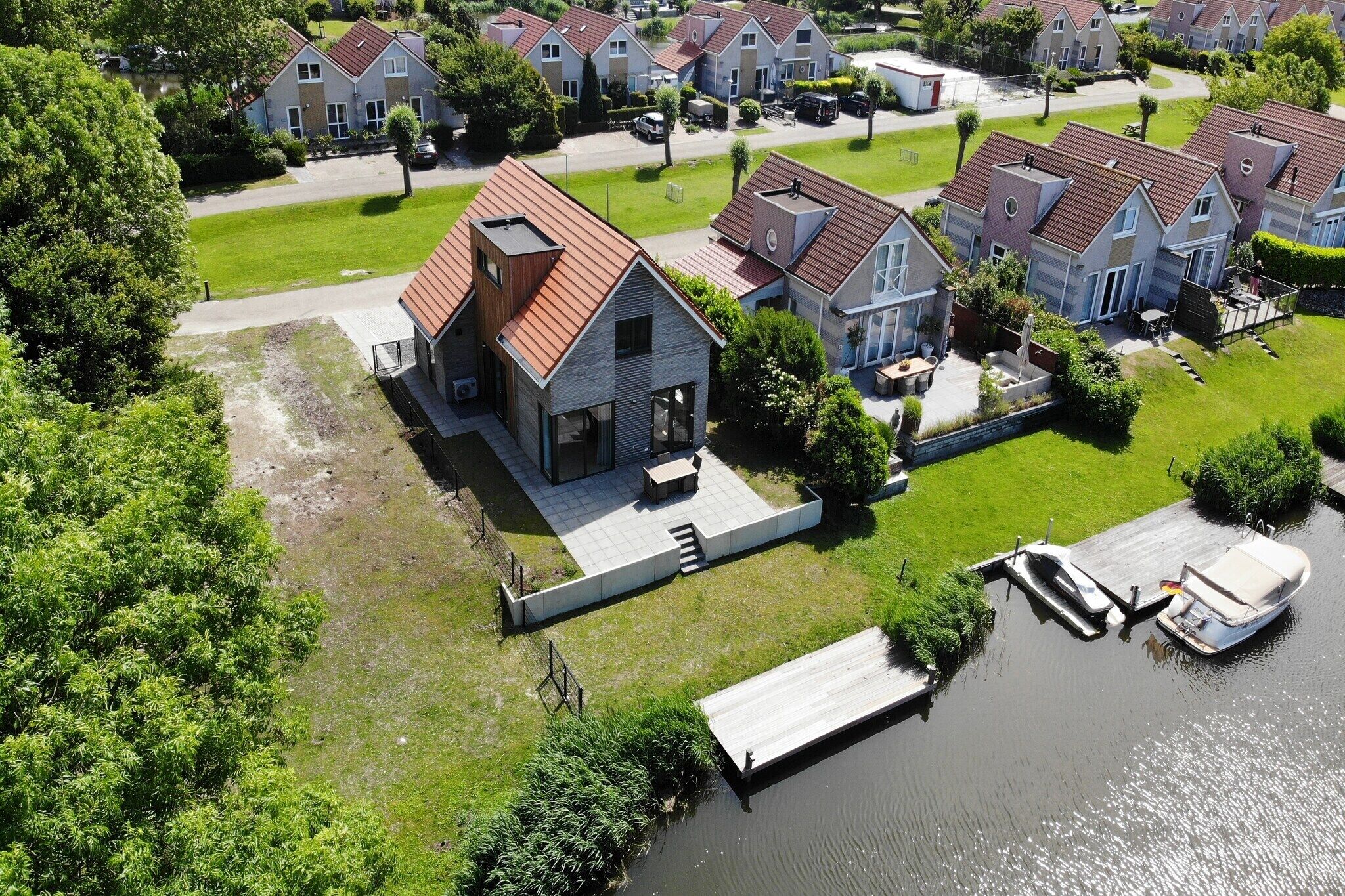 A residential area with houses, a dock, and a small boat.