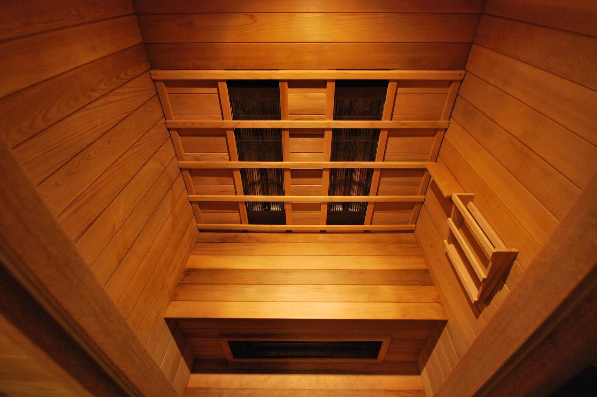 A sauna with wooden walls and benches.