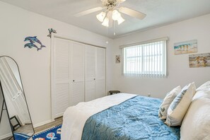 A bedroom with a bed, a ceiling fan, a window with blinds, and a closet. - Pool, Fishing Dock! Port Charlotte Canal-Front Gem (Port Charlotte)