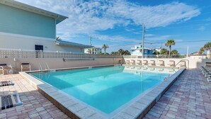 A swimming pool with a tiled deck, lounge chairs, and a fence. - Unwind Poolside, Walk to Shore! Ponce Inlet Escape (Ponce Inlet)