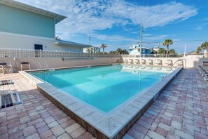 A swimming pool with a tiled deck, lounge chairs, and a fence. - Unwind Poolside, Walk to Shore! Ponce Inlet Escape (Ponce Inlet)