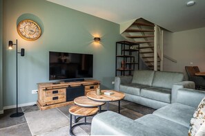 A living room with a television, sofa, and coffee table. - Farmhouse near De Koog (De Koog)
