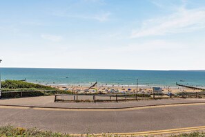 A coastal road leading to a beach with a clear view of the sea. - Ocean View Beach Apartment with Balcony & Parking (Bournemouth, Christchurch and Poole)
