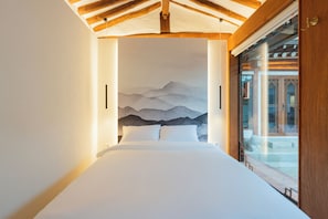 A bedroom with a bed, a mountain mural, and a sliding glass door leading to an outdoor area. - Private Hanok in Ikseon-dong · Jacuzzi & Courtyard · Sleeps up to 10 (종로구)
