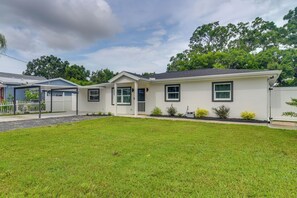 A single-story house with a front porch, a garage, and a well-maintained lawn. - Sleek & Central! Safety Harbor Home Near Beaches (Safety Harbor)
