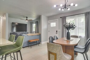 A modern kitchen with a built-in oven and a dining area with a round table and chairs. - Sleek & Central! Safety Harbor Home Near Beaches (Safety Harbor)