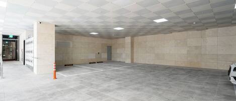 A spacious indoor area with a tiled floor and a checkered ceiling.