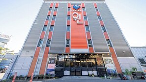 A hotel building with a prominent 'HOTEL' sign, a coffee shop entrance, and a 'WIN' logo. - Andong Win Hotel (Andong)