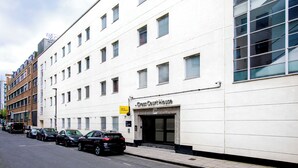 A building with a sign reading 'Cross Court House' and a yellow sign indicating 'Unite Students'. - Student Only Cross Court House (London)