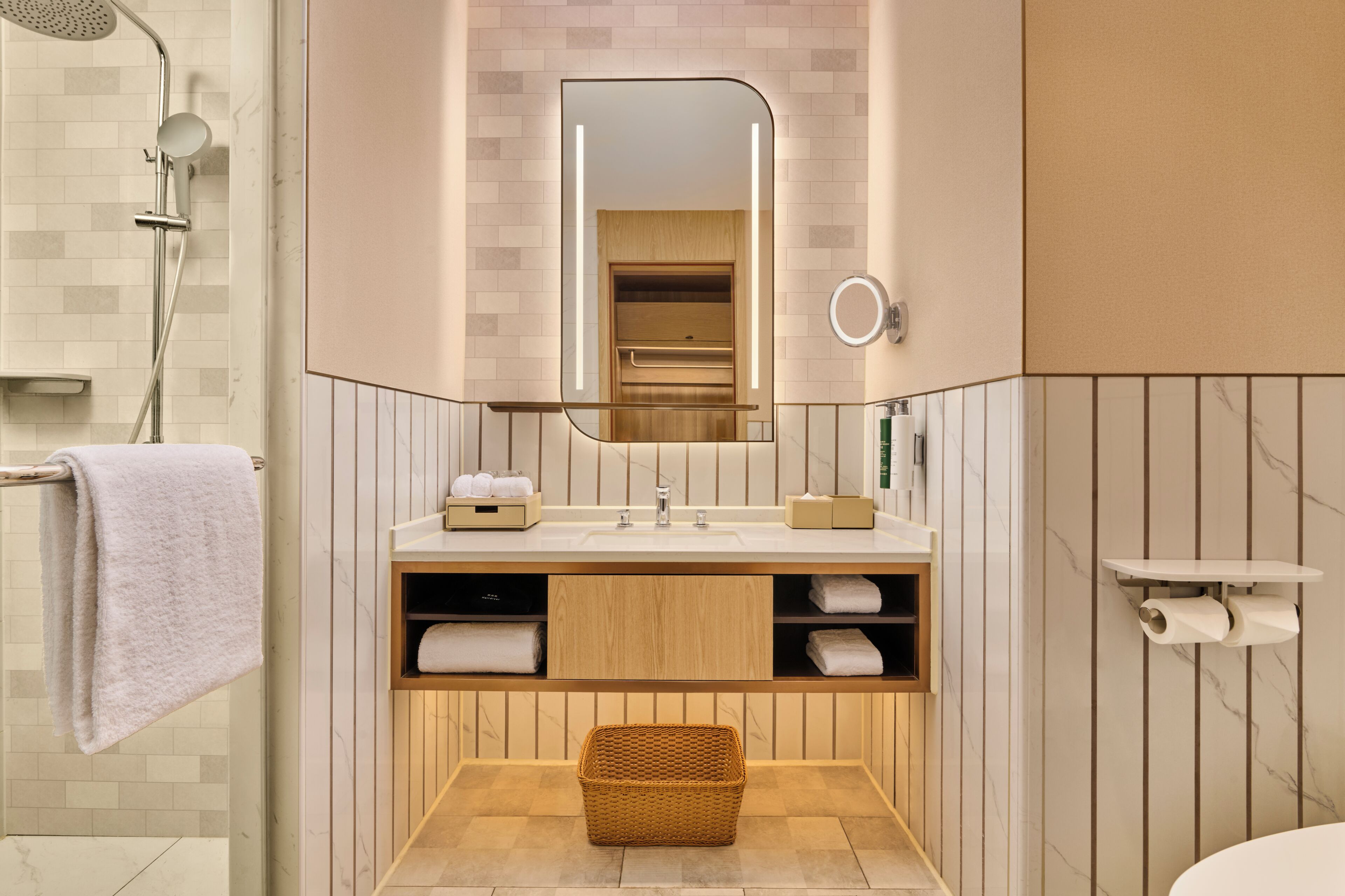 A modern bathroom with a shower, a vanity with a mirror, and a toilet.