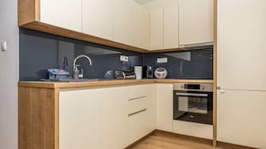 A compact kitchen with a built-in oven, a microwave, and a sink. - Villa Jura by Villas Guide (Bribir)