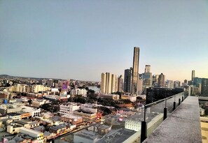 A cityscape with high-rise buildings, a river, and a pedestrian walkway. - Fortitude Valley Pool Sauna & Gym (Brisbane)