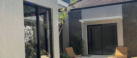 A modern house with a swimming pool, large windows, and outdoor seating.