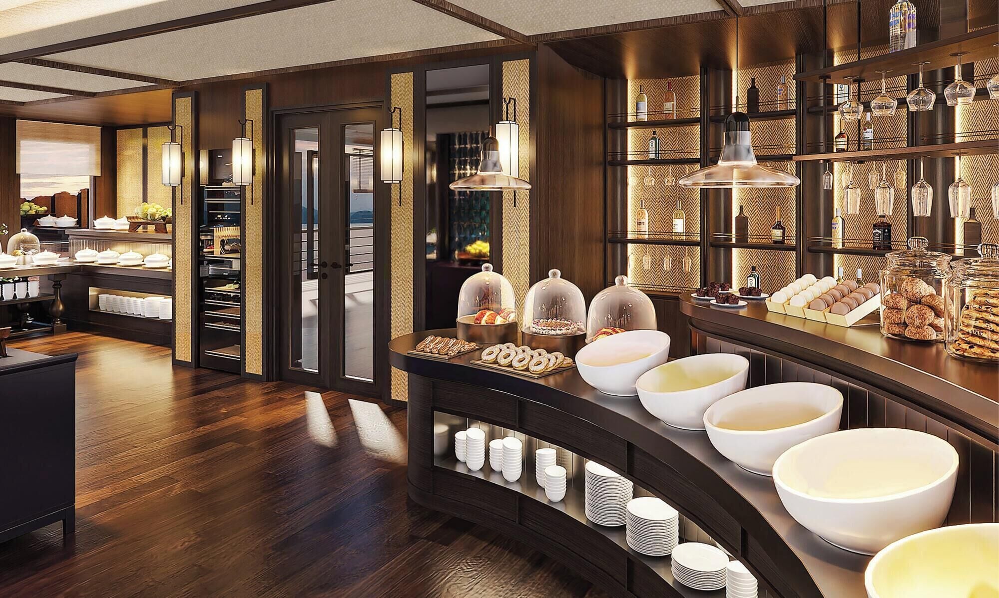 A hotel buffet area with a variety of food items, including pastries and desserts, and a selection of beverages.