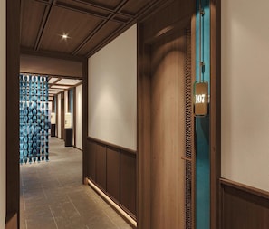 A hallway with a wooden door labeled '107' and a decorative blue wall. - Orchid Luxury Cruise (Bai Chay)