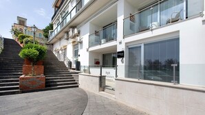A modern building with a staircase leading to a balcony, a sign with the name 'HADDAR', and a contact number. - 'Haddar Etna' – Sapphire (Zafferana Etnea)
