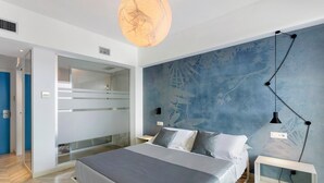 A modern bedroom with a bed, a wall-mounted light, and a large window. - 'Haddar Etna' – Sapphire (Zafferana Etnea)
