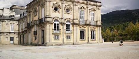 A historic building with a courtyard, large windows, and classical architecture.