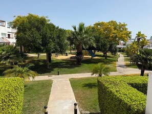 A landscaped outdoor area with pathways, benches, and various trees. - Alhama County - Apartment 186 N3 (MC)