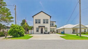 A two-story building with a front porch and a garage.