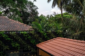 A traditional tiled roof structure surrounded by dense tropical vegetation. - Staymaster Shangrila-4BR Private villa  (Marra)