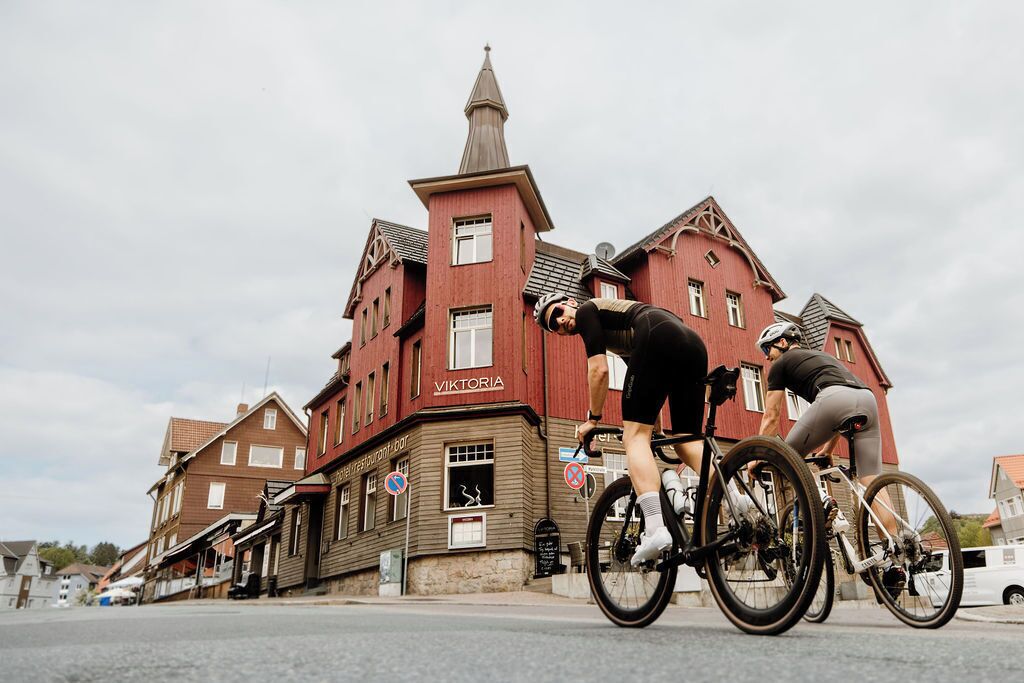 A building with a sign that reads 'VIKTORIA' and a cyclist in front of it.