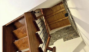 A wooden staircase with a stone wall at the bottom. - NEW LarioView Suites – Lake View Apartment with Terrace in Argegno (Argegno)