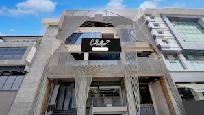 A modern building with a prominent 'Collection' sign, featuring a geometric facade and a staircase leading to the entrance. - Shahpura Lakeview (Bhopal)