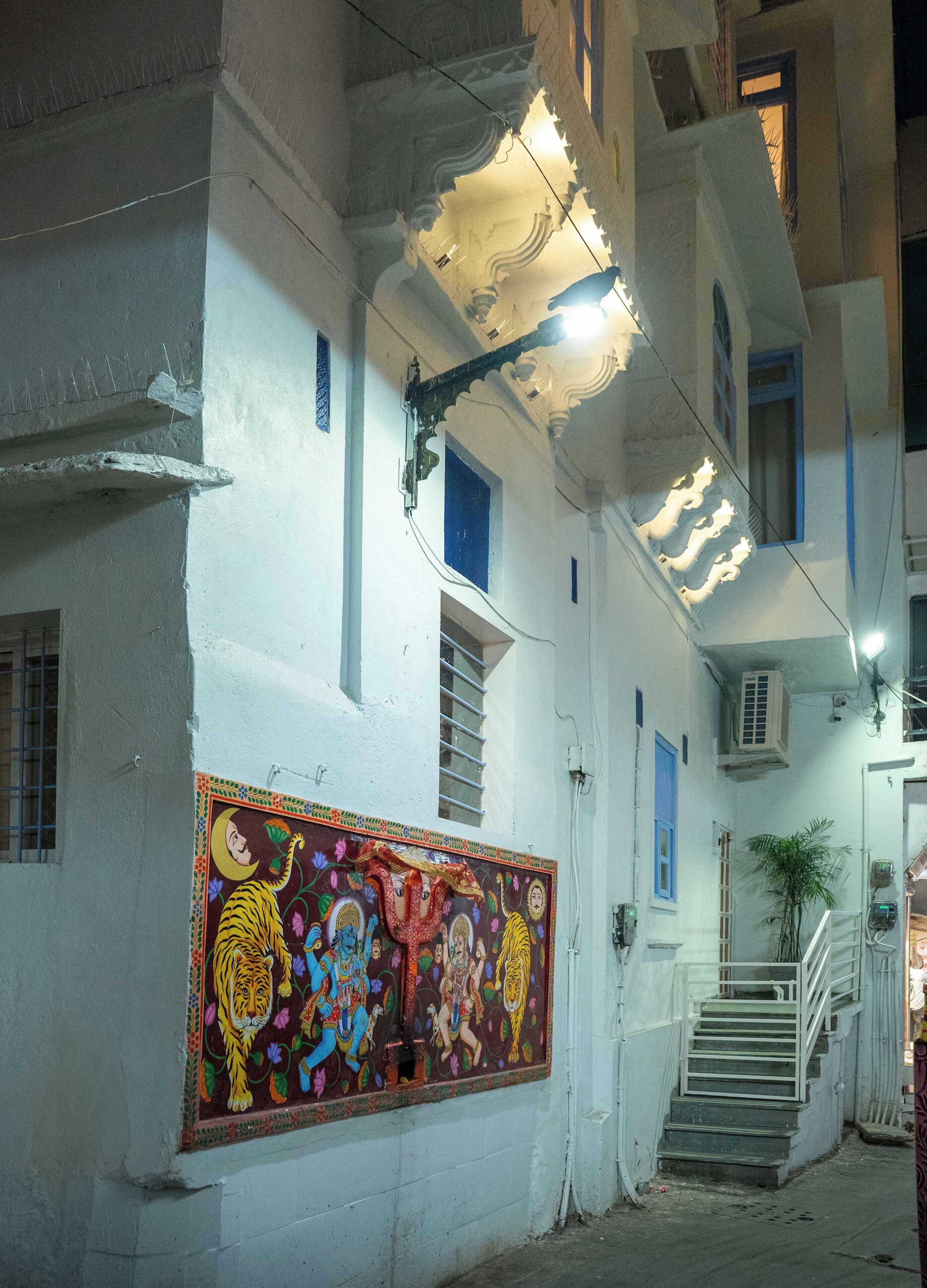 A building with a mural, a staircase, and a staircase railing.
