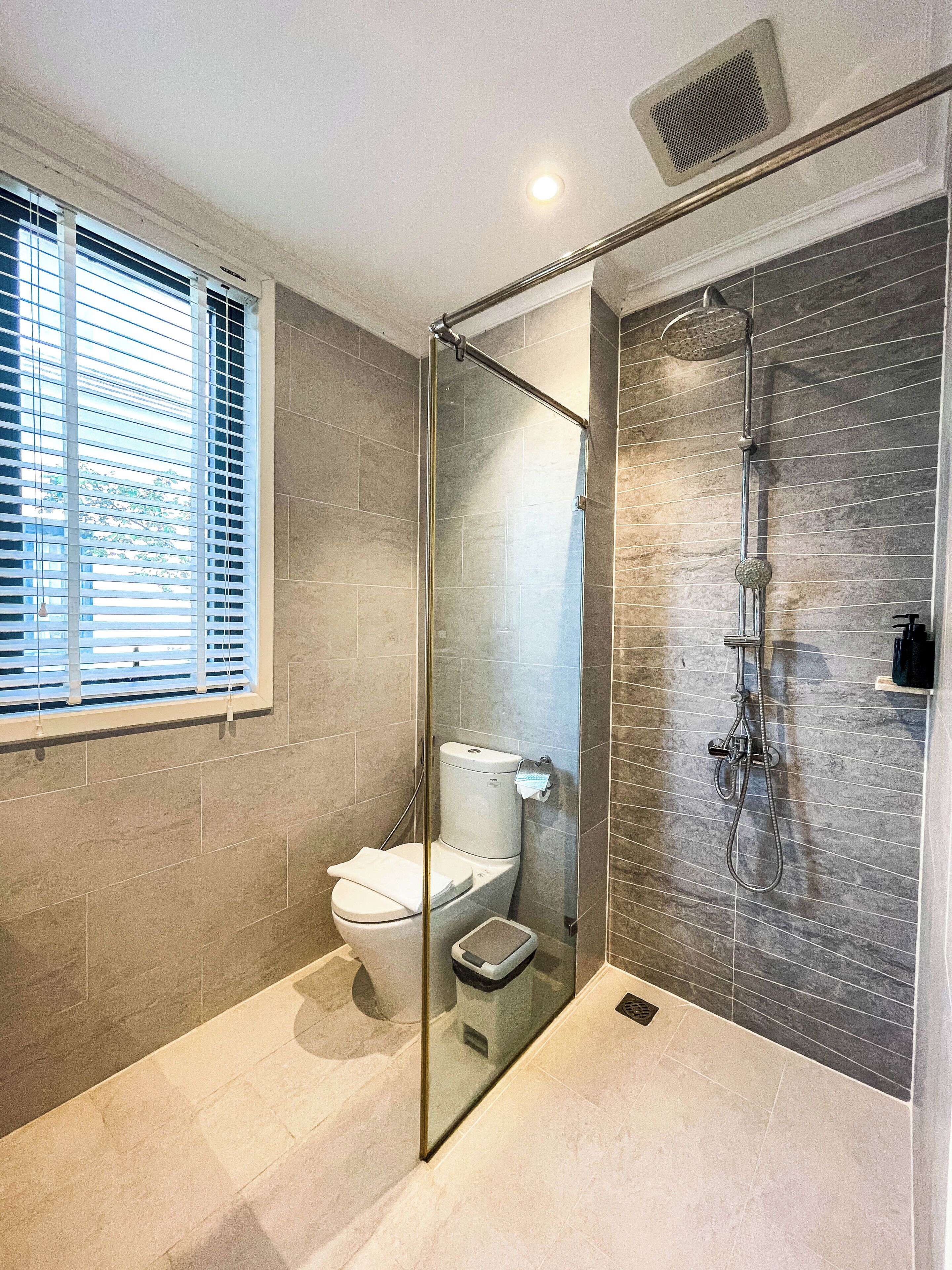 Separate tub and shower, hair dryer, slippers, towels