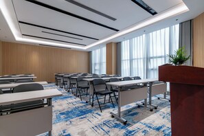 A conference room with tables, chairs, a podium, and large windows. - YIBON INTERNATIONAL HOTEL (Guiyang)