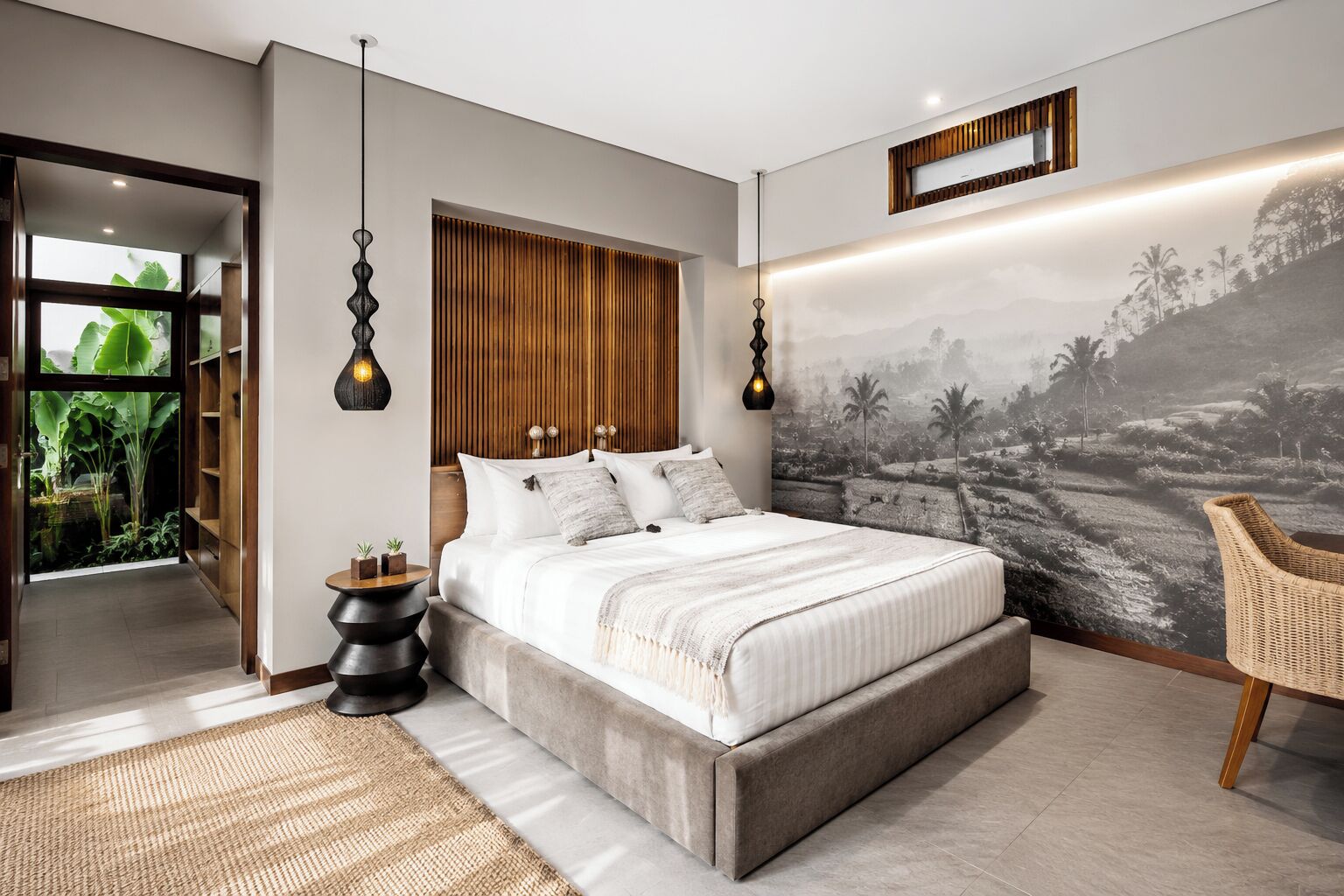 A modern bedroom with a large bed, a view of greenery through a glass door, and a wall mural.