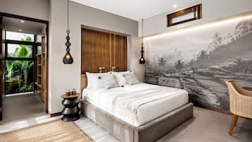 A modern bedroom with a large bed, a view of greenery through a glass door, and a wall mural.