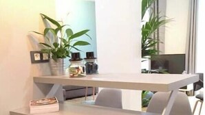 A modern kitchen with a dark blue cabinet, a white countertop, and a built-in sink. - Spacious, recently renovated apartment near the Louvre (Île-de-France)