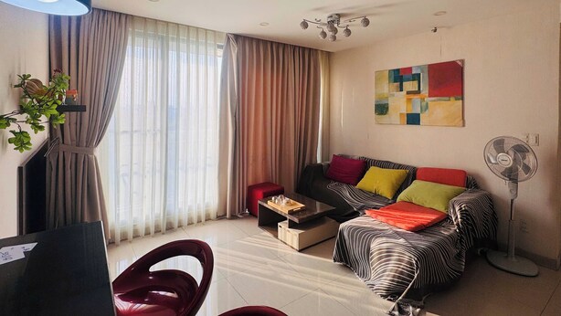 A modern living room with a sofa, a coffee table, and a floor lamp. - Green Valley EmHouse (Ho Chi Minh City)