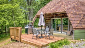 A wooden deck with a grill and outdoor seating. - Whispering Oaks Dome Retreat / Sleeps 9 / Private Woodland Escape (Saint Croix Falls)