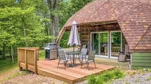 A wooden deck with a grill and outdoor seating. - Whispering Oaks Dome Retreat / Sleeps 9 / Private Woodland Escape (Saint Croix Falls)