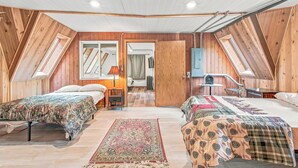 A bedroom with two beds, a wooden ceiling, and a skylight. - Whispering Oaks Dome Retreat / Sleeps 9 / Private Woodland Escape (Saint Croix Falls)