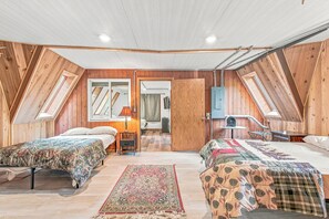 A bedroom with two beds, a wooden ceiling, and a skylight. - Whispering Oaks Dome Retreat / Sleeps 9 / Private Woodland Escape (Saint Croix Falls)