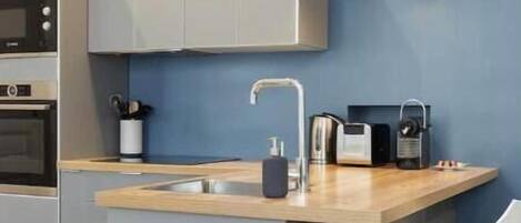 Una cocina moderna con una isla integrada, un fregadero y un taburete de bar.