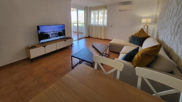 A living room with a television, sofa, and a dining table. - El Rincon 12 - One Bed (Los Cristianos)
